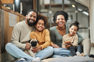 Happy family sitting together and smiling representing family dental care. Hayden Dental Care provides comprehensive dental services for patients of all ages.
