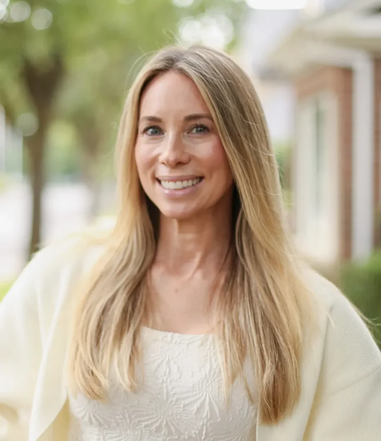 Smiling female dentist from Hayden Dental Care standing outdoors. She represents the friendly and experienced dental team providing quality care.