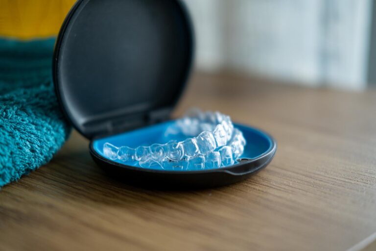 Clear aligners placed inside a protective case used for orthodontic teeth straightening. Clear aligner treatment helps patients achieve a straighter and healthier smile.