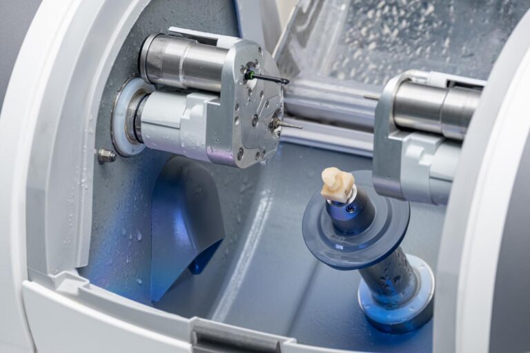 Dental milling machine creating a custom crown for a patient. Modern dental technology helps Hayden Dental Care provide precise and efficient restorations.
